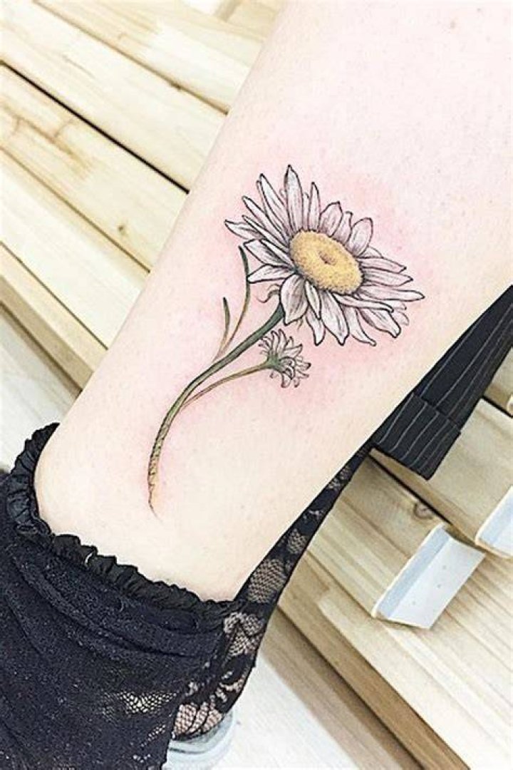 Daisy thigh tattoo done at Aces High in West Palm Beach daisytattoo 